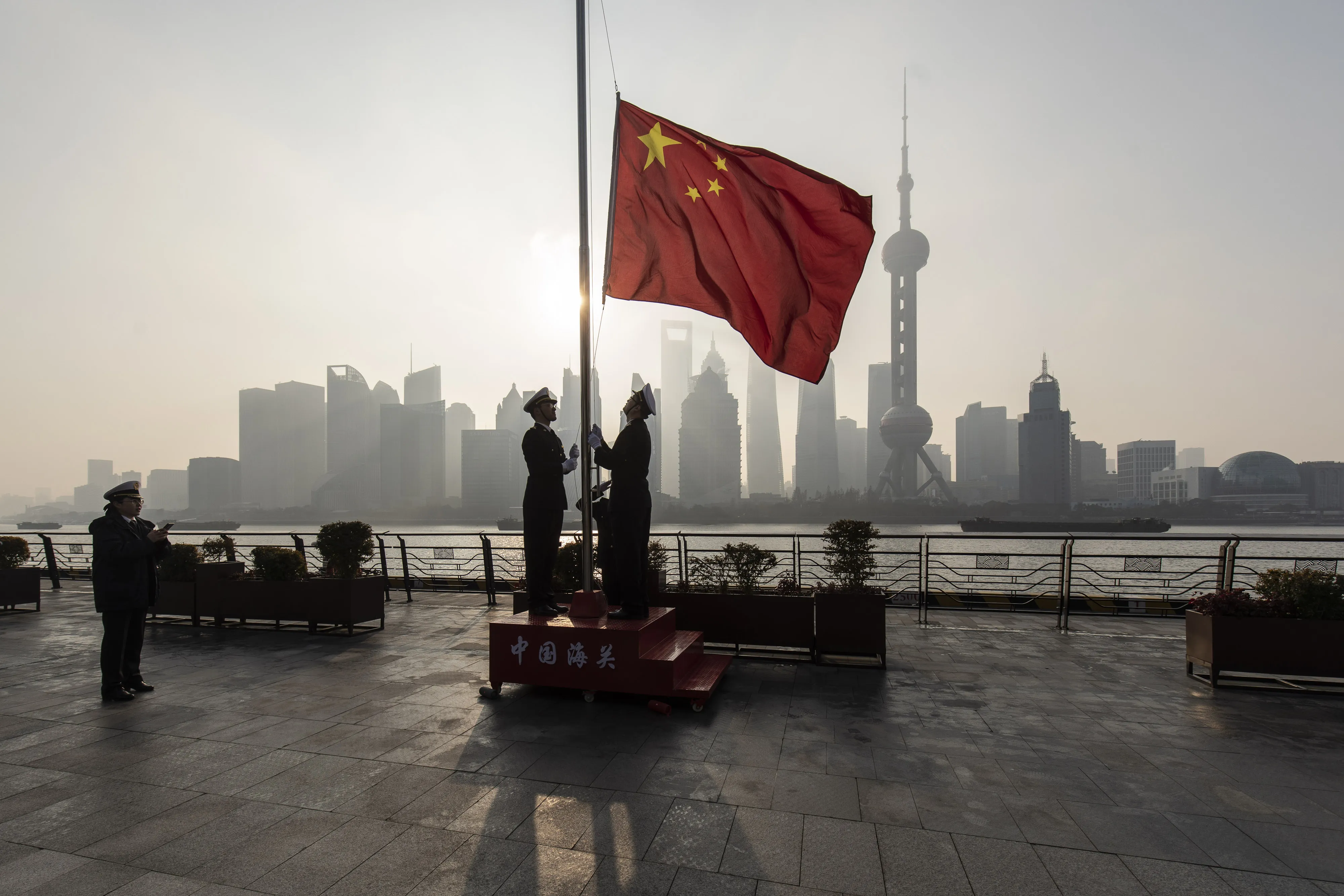 China Customs officers raise a Chinese flag in Shanghai.&nbsp;