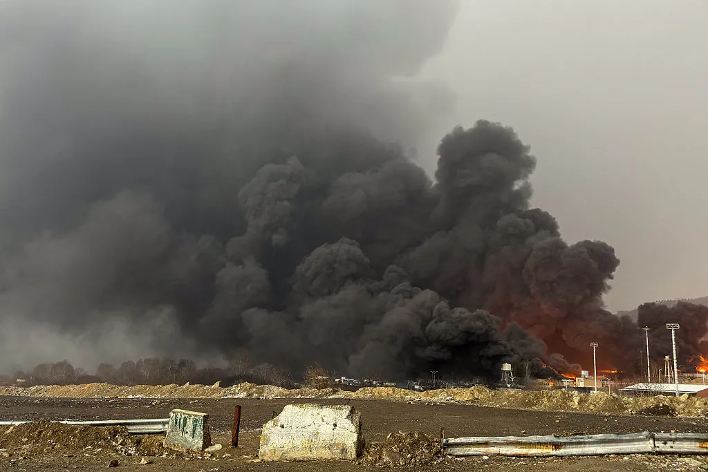 Smoke and flames rise at the site of airstrikes on an oil depot in Tehran on March 8.