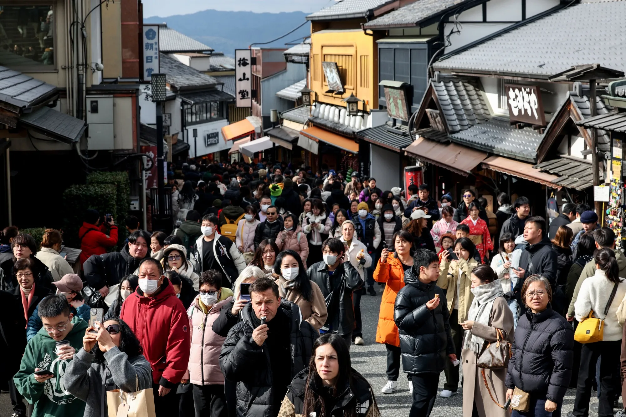 Tourists walk past shops and restaurants up the hill leading to Kiyomizu-dera Temple in Kyoto on Jan. 13.