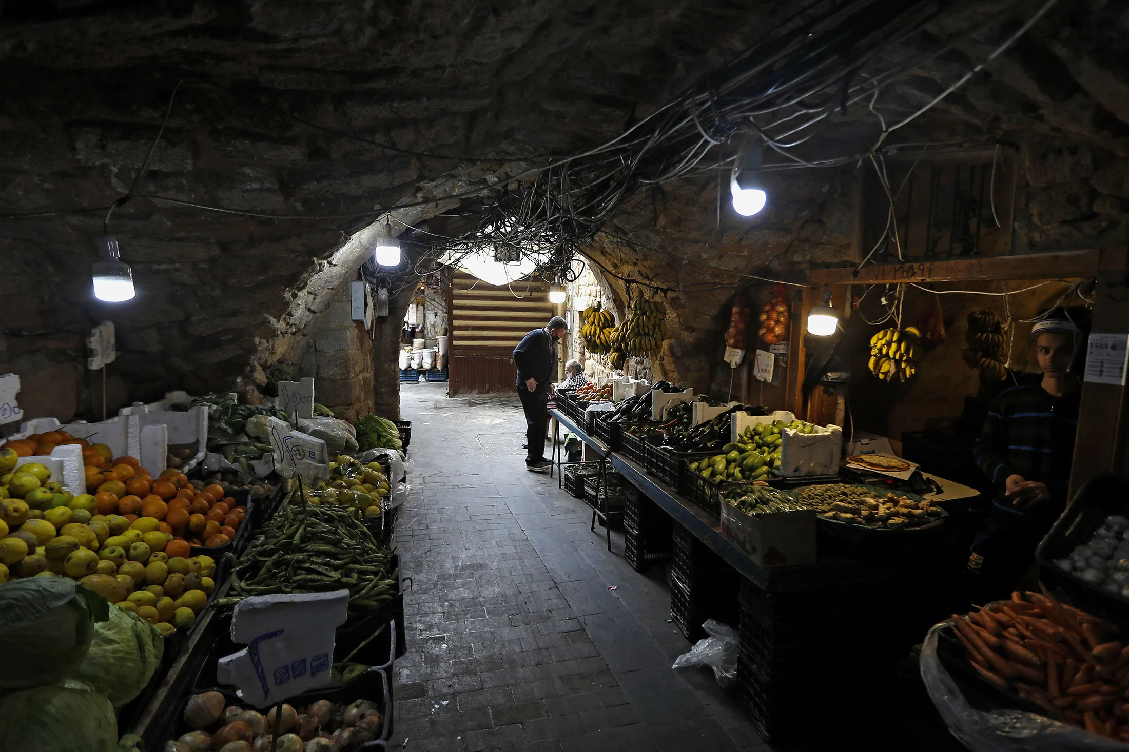 A man buys fresh produce in the market of the historic part of the southern coastal city of Sidon, Lebanon, on April 6.