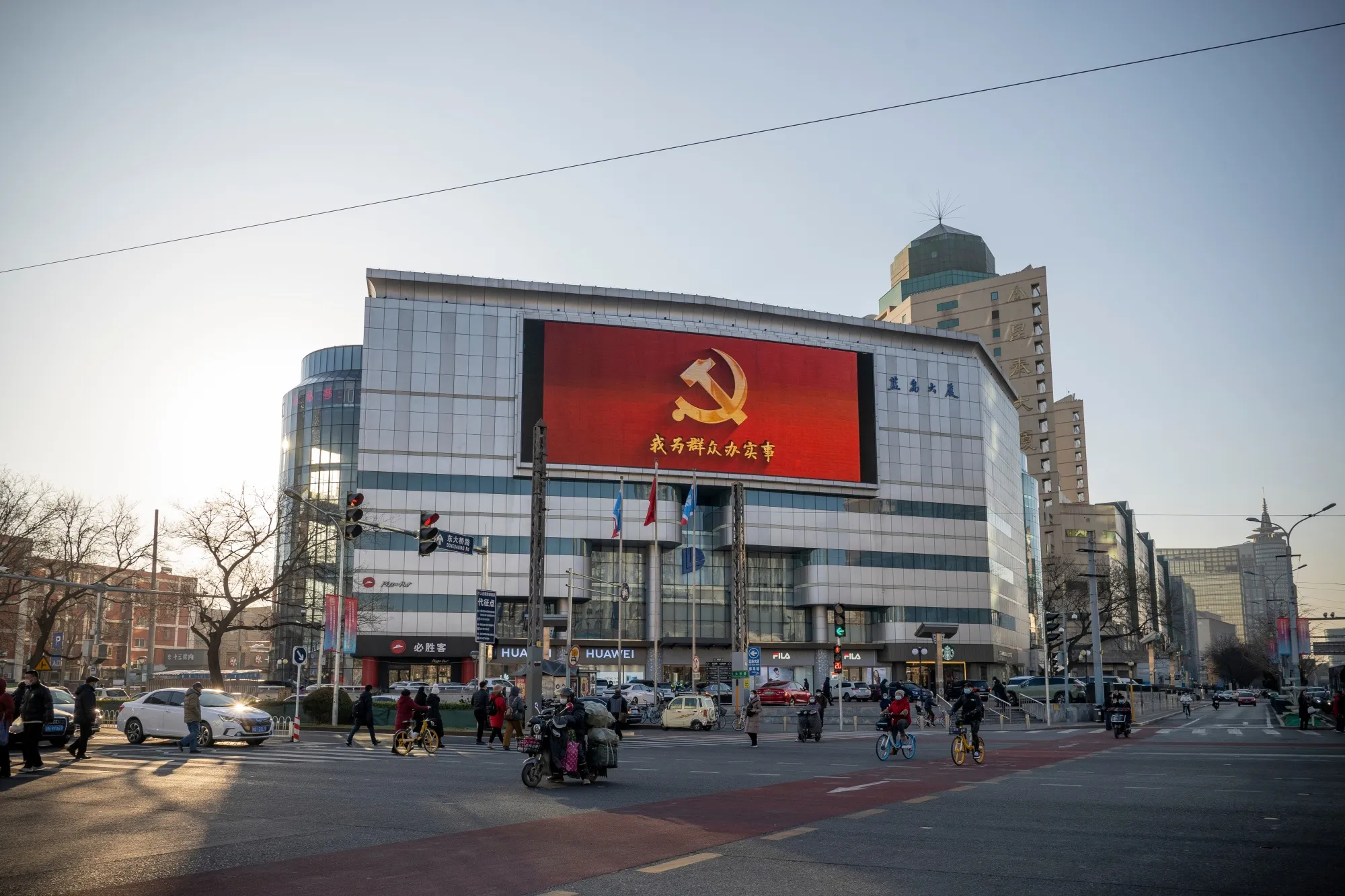 A screen displays the emblem of the Chinese Communist Party in Beijing, China.