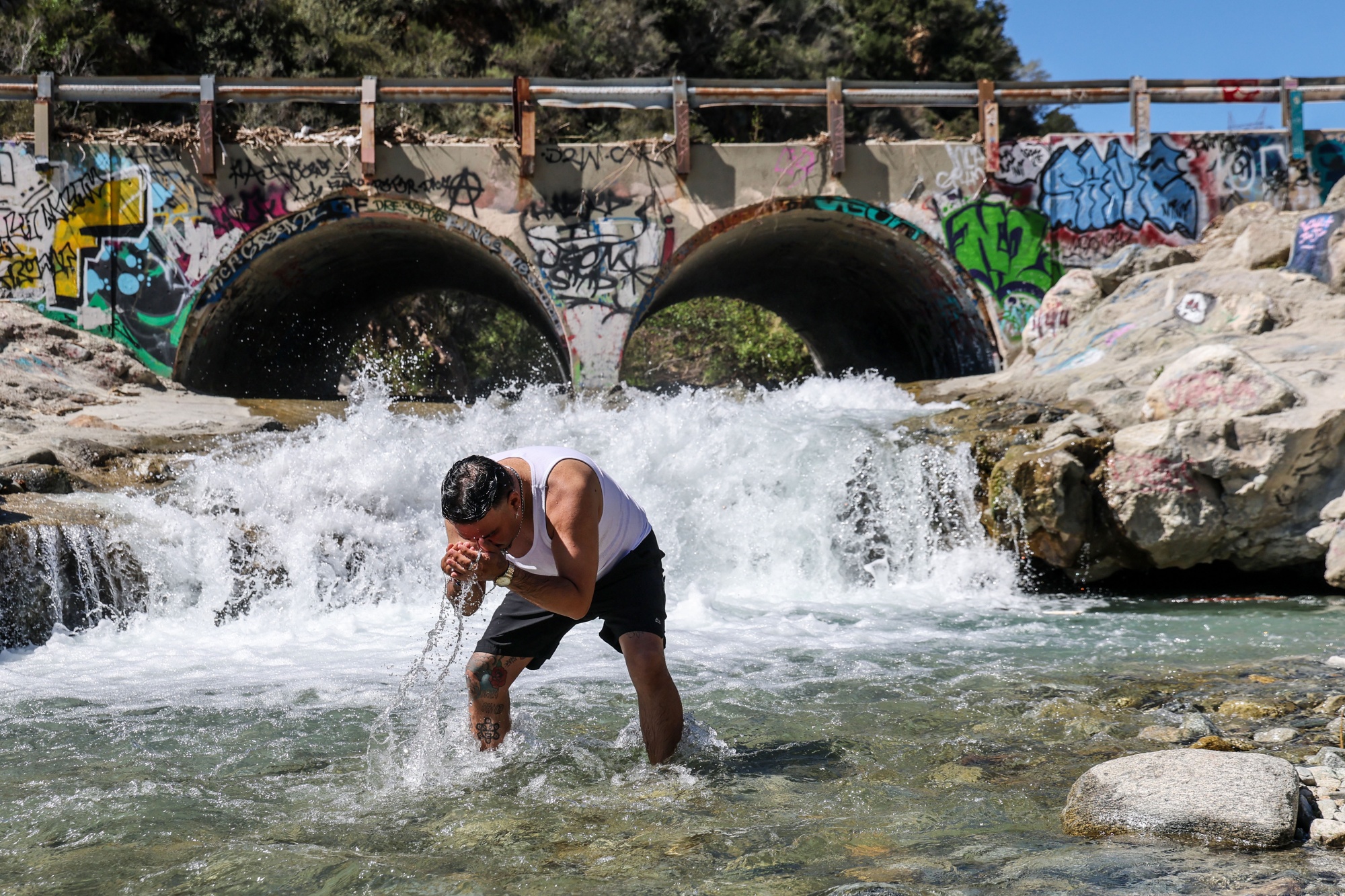 Joel Castillo of Montclair, cools off in Lytle Creek on in Lytle Creek, California on March 12. Photographer: Robert Gauthier/Los Angeles Times/Getty Images