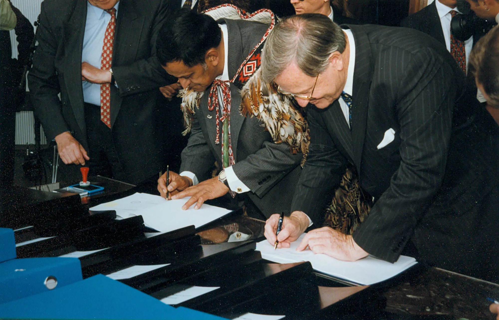 Ngai Tahu leader Charles Crofts and New Zealand Prime Minister Jim Bolger sign the Deed of Settlement in 1997.