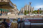Customers sit at a terrace overlooking Duomo Cathedral in Milan, May 27.