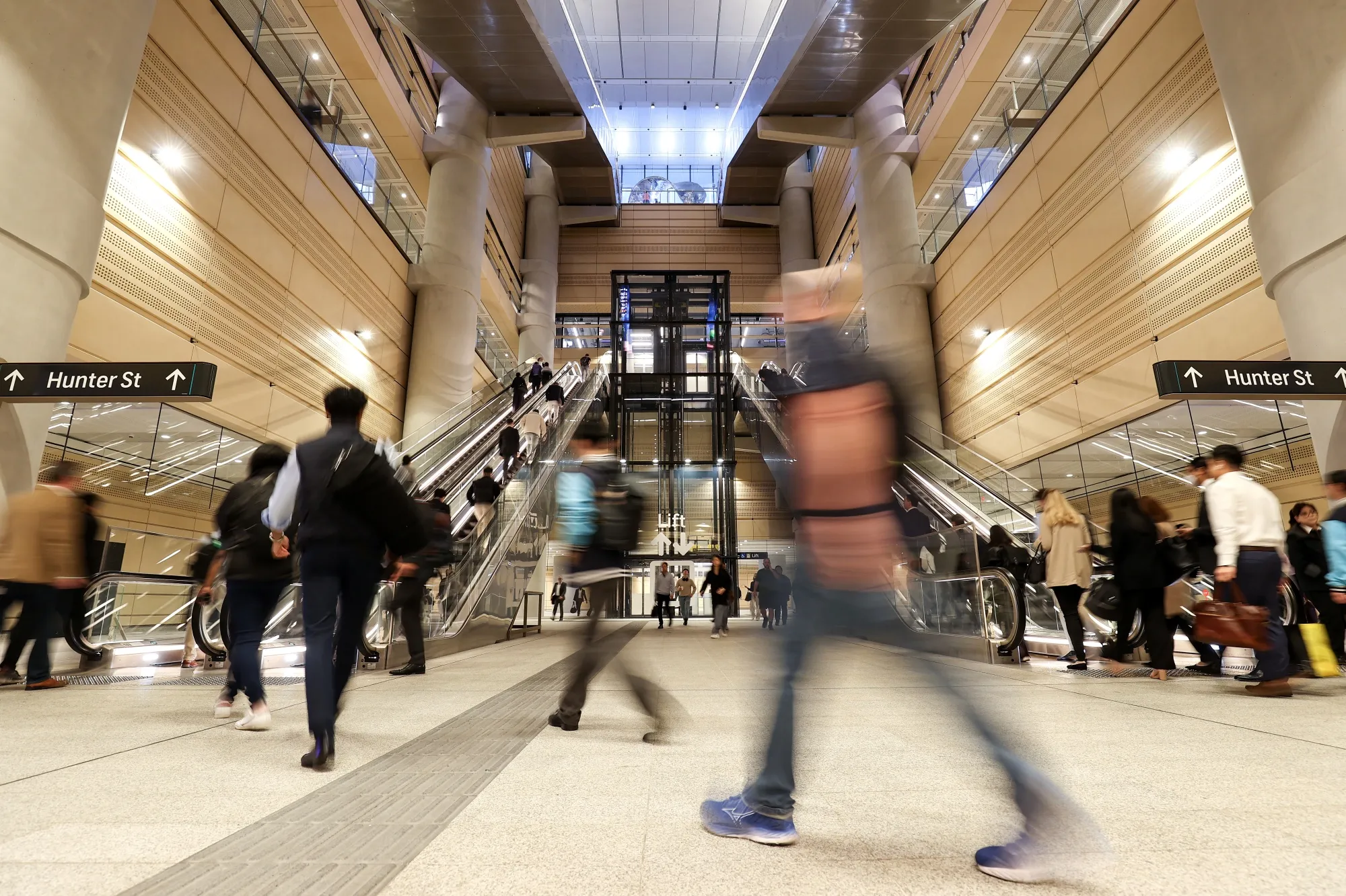 Commuters walk through Martin Place Metro Station in Sydney, Australia.