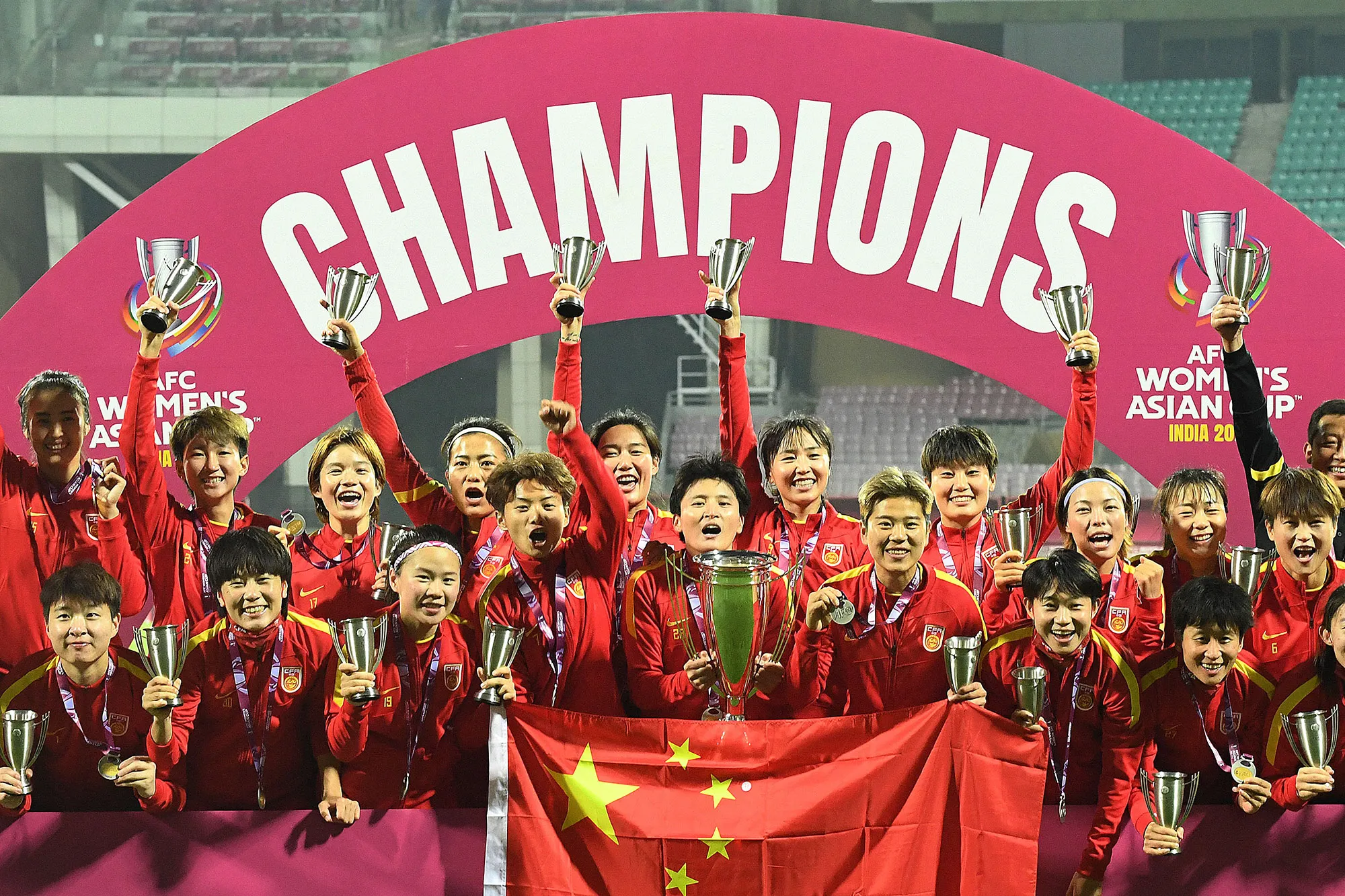 China players celebrate with the trophy after their win in the AFC Women’s Asian Cup, on Feb. 6.