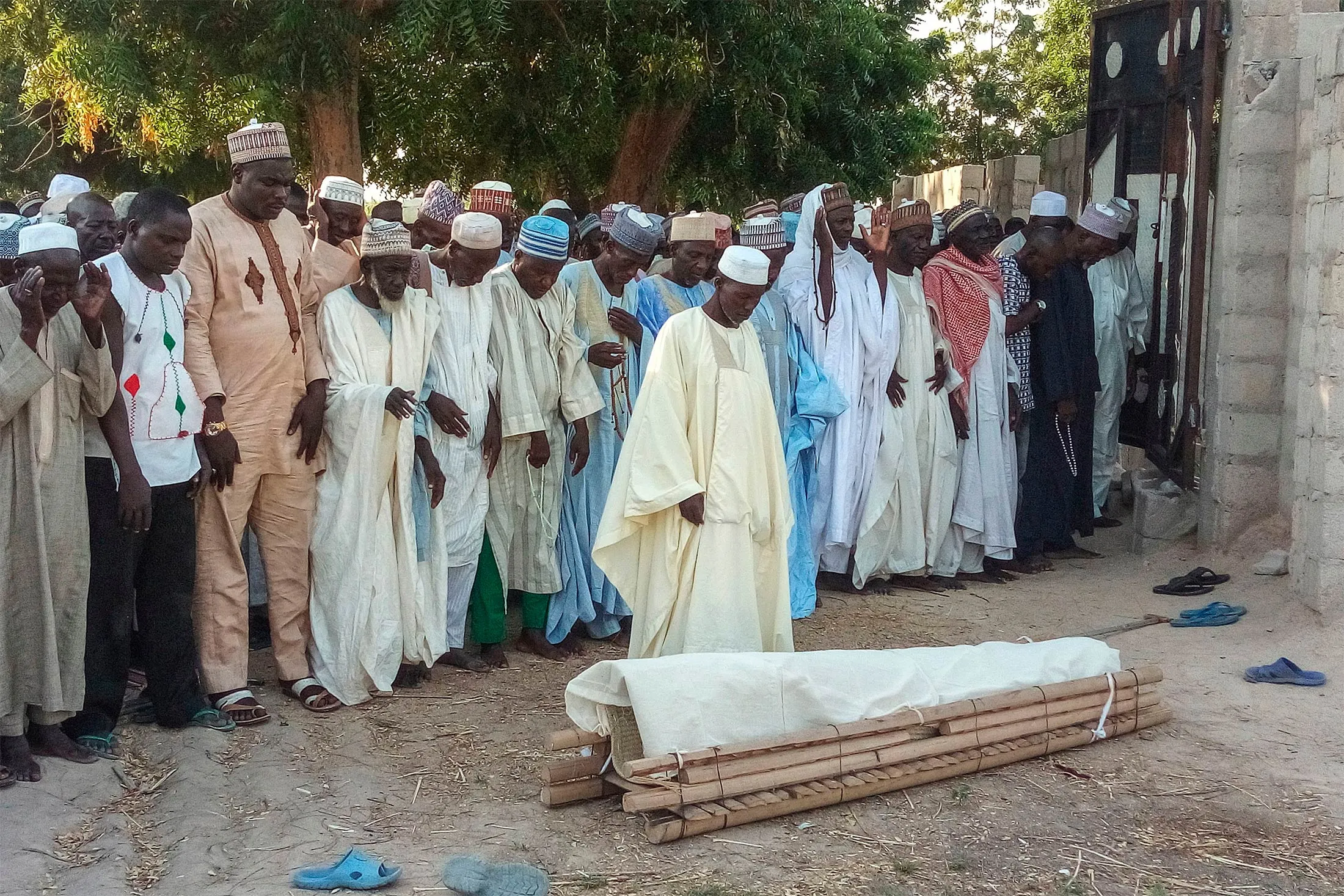 Men take part in the burial prayer for one of the farmers killed by Boko Haram militants in Kalle, a remote village 17 kilometers outside of&nbsp;Maiduguri, Nigeria, on Oct. 20, 2018.&nbsp;