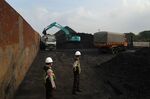 An excavator loads coal at Cirebon Port in West Java, Indonesia.