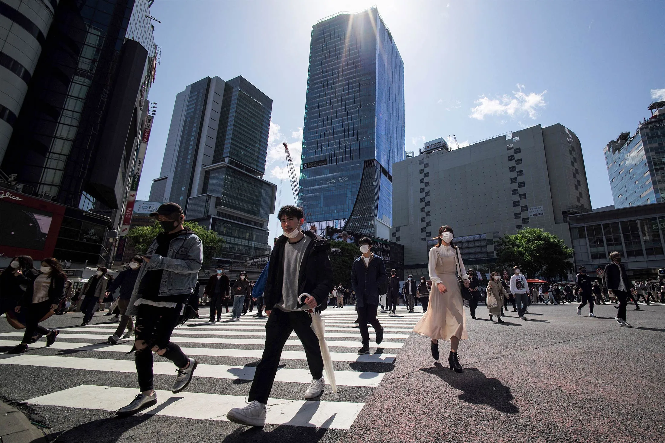 Pedestrians cross a street in Tokyo on April 18.