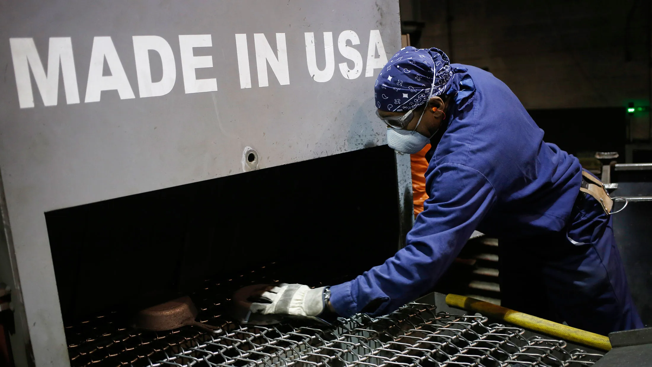 An assembly line worker loads cast iron cookware in South Pittsburg, Tennessee.
