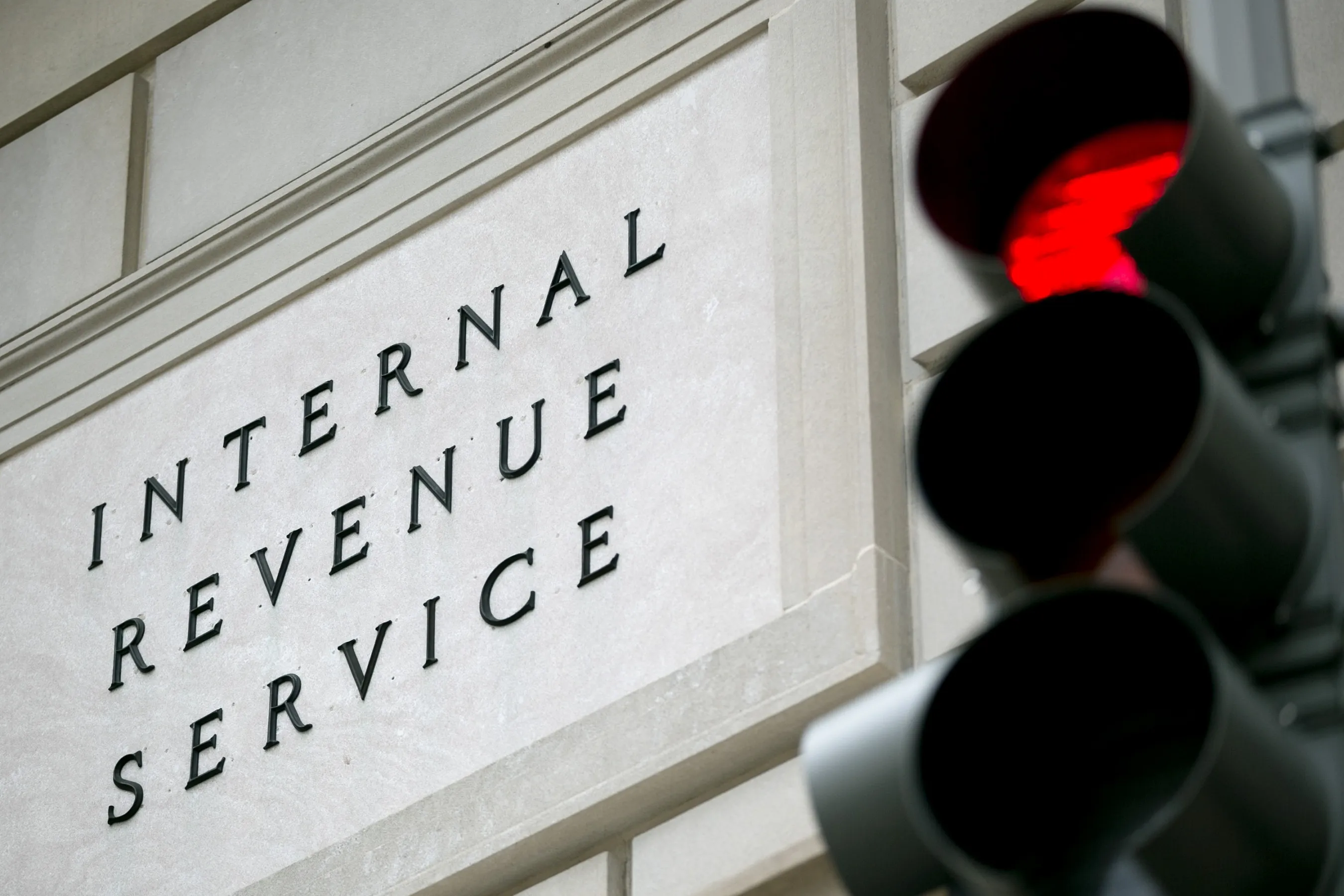 A red stoplight stands in front of the Internal Revenue Service (IRS) headquarters in Washington, D.C., U.S., on Wednesday, May 15, 2013. The widening inquiries into the IRS are focusing less on why employees singled out small-government groups for scrutiny and more on agency executives who didn't inform Congress earlier.