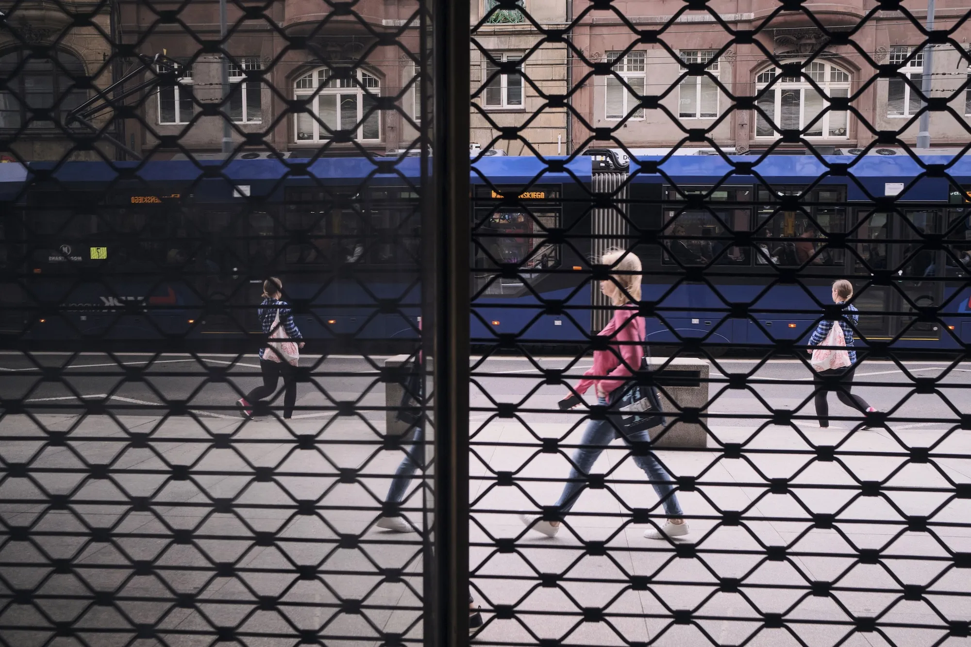 A tram passes pedestrians during afternoon rush hour in Wroclaw, Poland.
