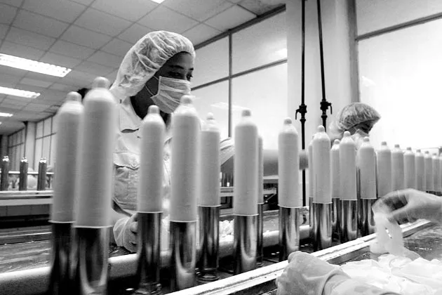 Women work at a condom manufacturing factory in Qingado, China, in 2004