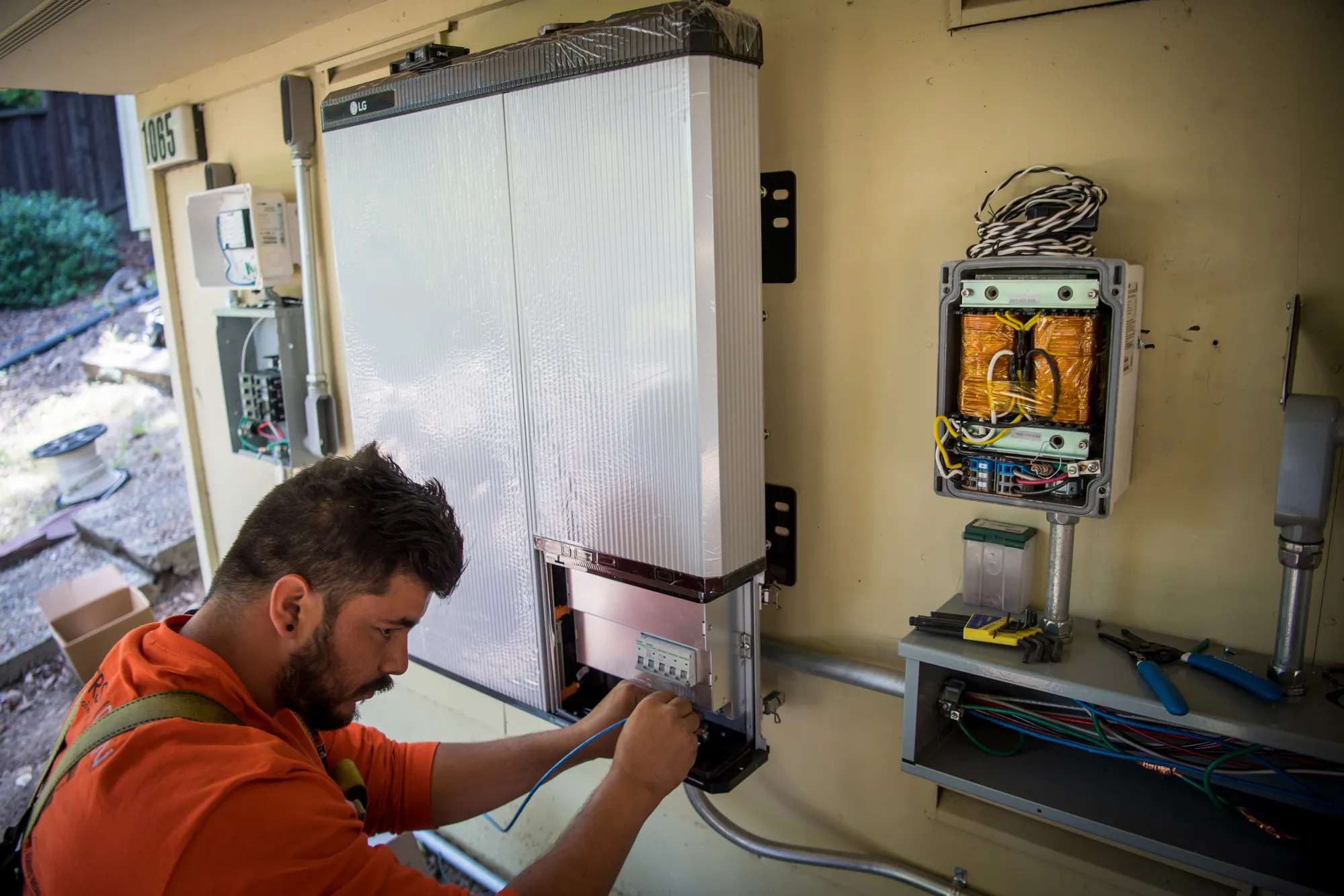 A worker installs wiring for a LG Electronics Inc. solar battery on a home in Lafayette, California, which became the first state in the U.S. to require solar panels on almost all new homes&nbsp;built after Jan. 1, 2020.