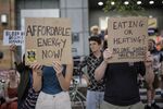 Protesters hold placards during a demonstration against rising energy prices outside Ofgem's headquarters in Canary Wharf on Aug.&nbsp;26.