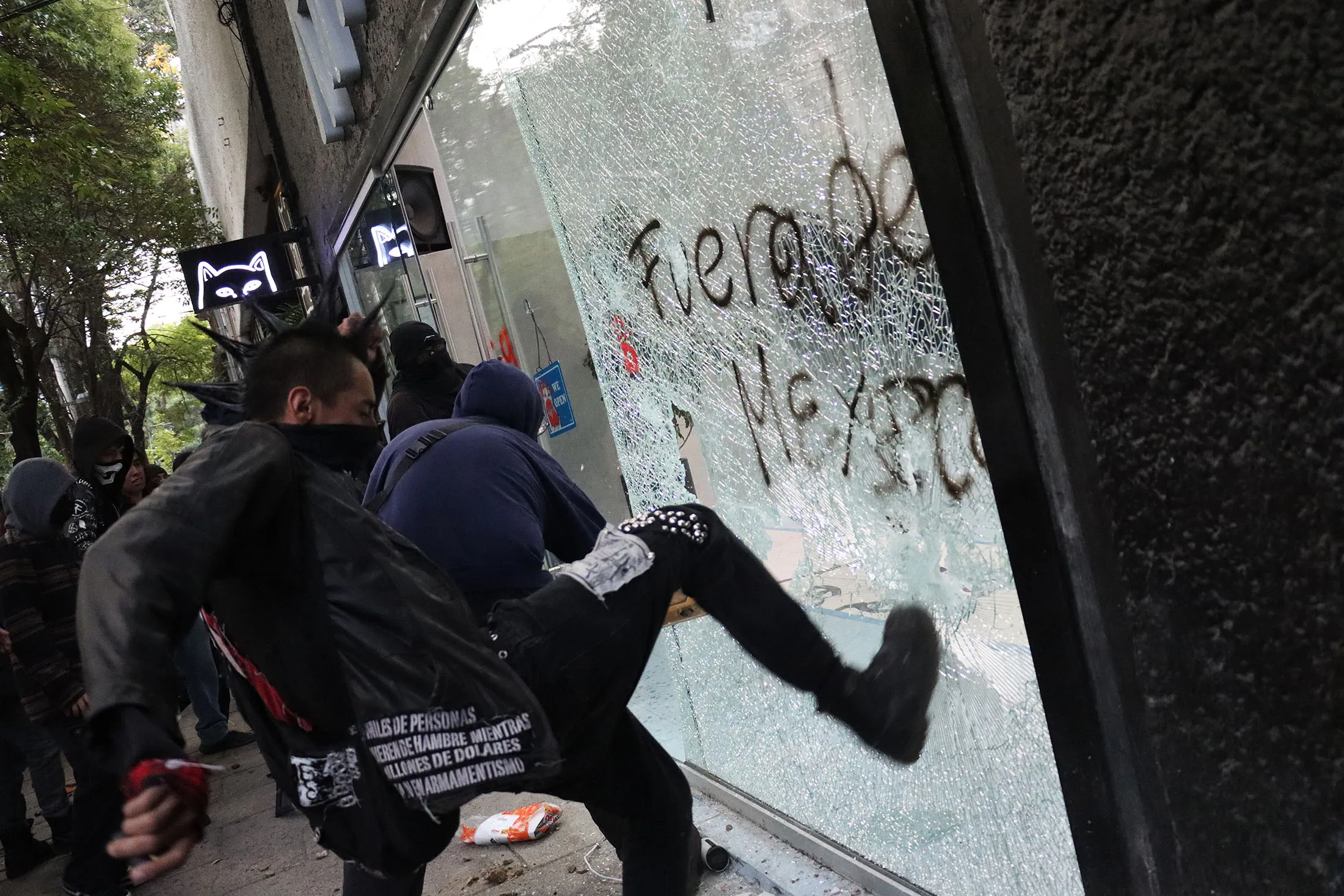 Demonstrators vandalize a retail store during a protest against gentrification in Mexico City on July 4.