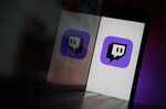 A smartphone displays a logo for the Twitch streaming app.