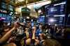 Traders work during the first day of trading for Spotify Technology SA on the floor of the New York Stock Exchange (NYSE) in New York, U.S., on Tuesday, April 3, 2018. Spotify shares climbed in the minutes after it began trading through a direct listing. The company skipped the traditional initial public offering process in favor of a route rarely taken by large, established companies.
