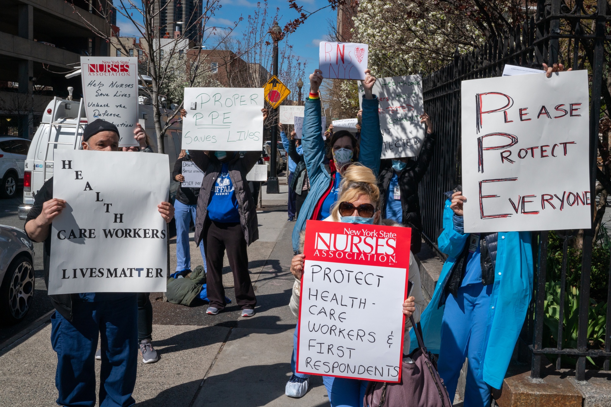 Nurses hold signs during a demonstration for increased personal protection equipment outside Montefiore Hospital in Bronx, April 2.