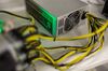 A bitcoin logo sits on a LL 1800W power unit supplying cryptocurrency mining machines at the SberBit mining 'hotel.'