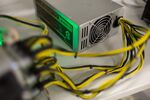 A bitcoin logo sits on a LL 1800W power unit supplying cryptocurrency mining machines at the SberBit mining 'hotel.'
