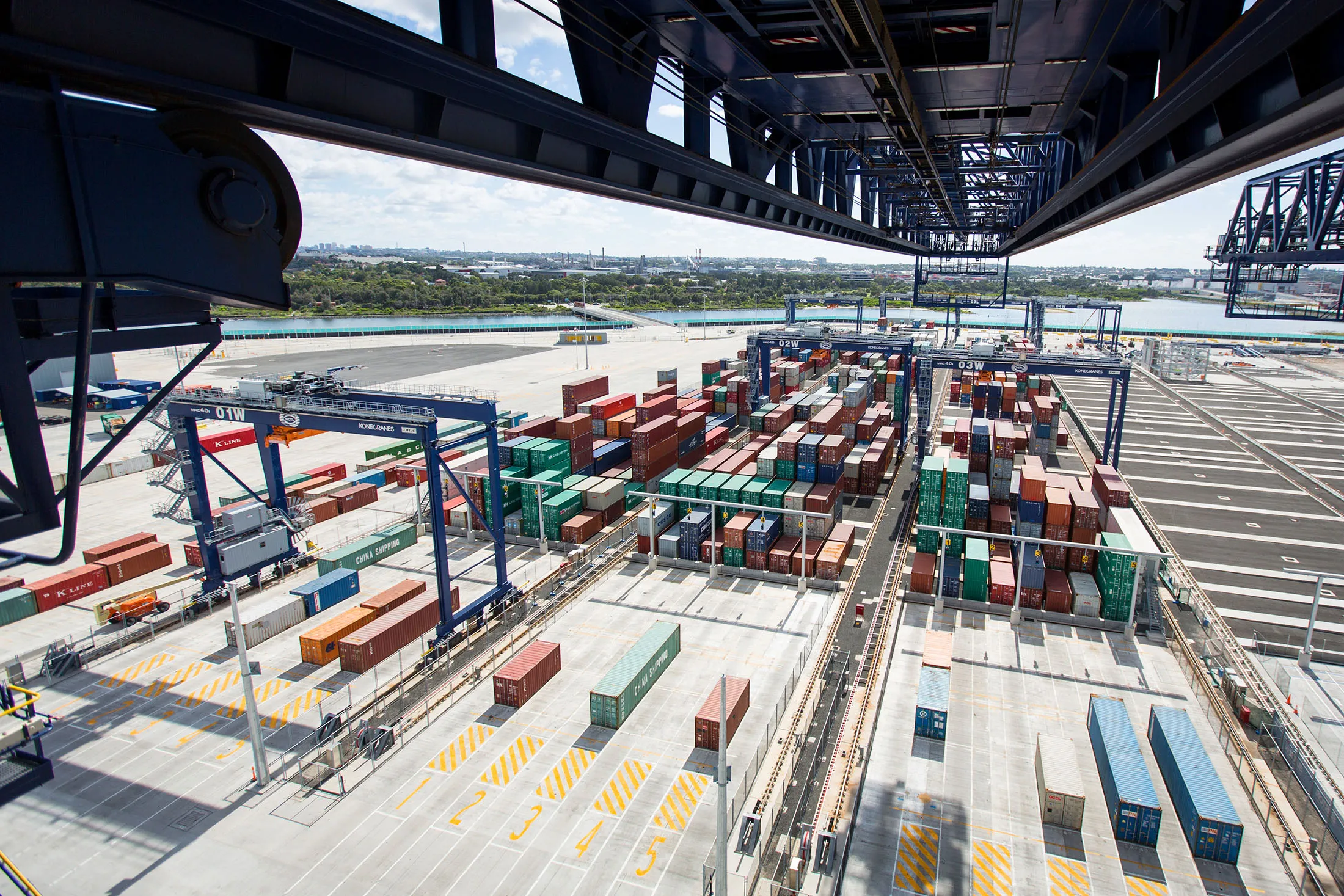 Shipping containers sit stacked among gantry cranes at Terminal 3 of Port Botany, Sydney,
