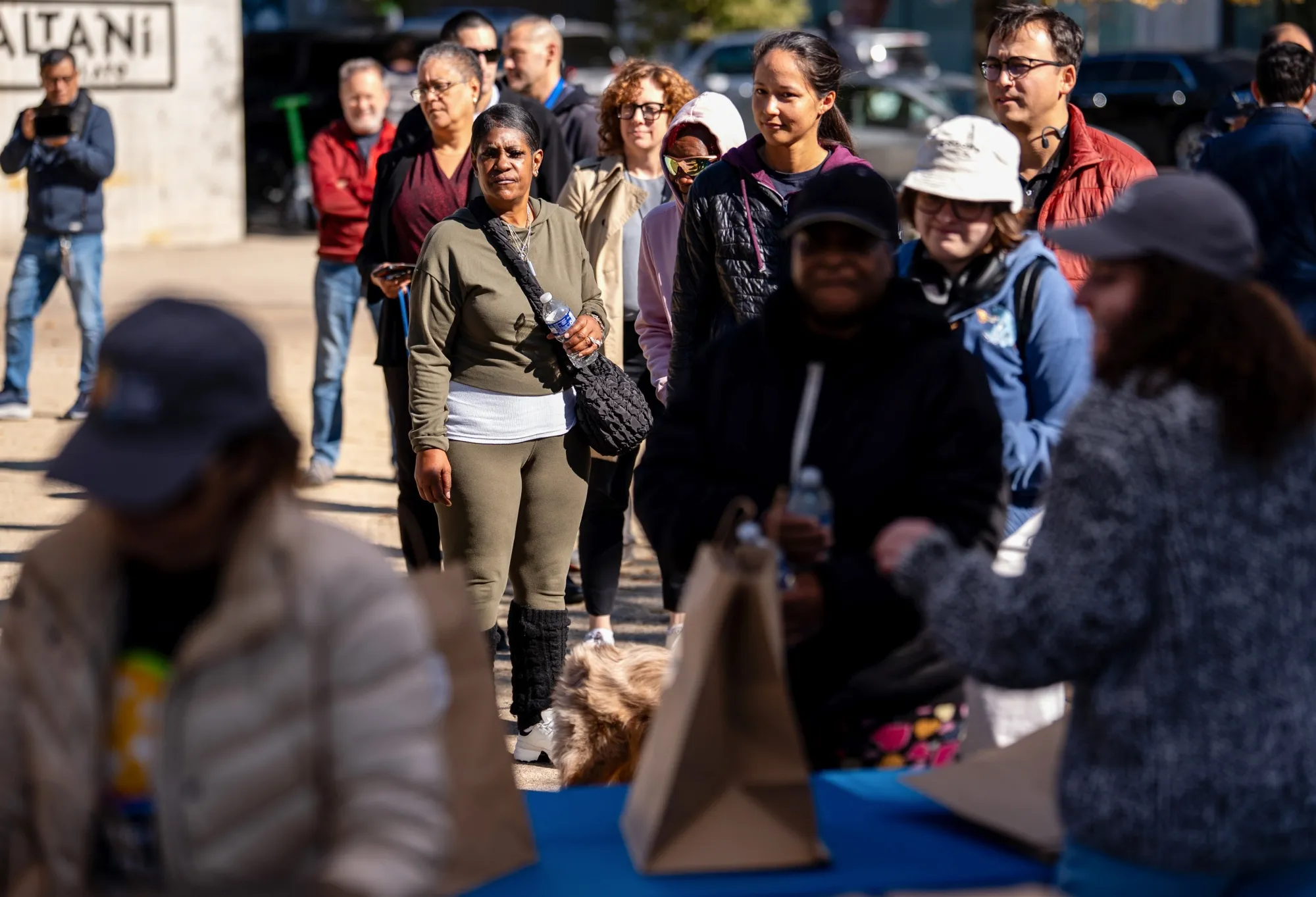 Residents wait in line at Jose Andres' World Central Kitchen free meal distribution site for furloughed federal workers in Washington on Oct. 27.