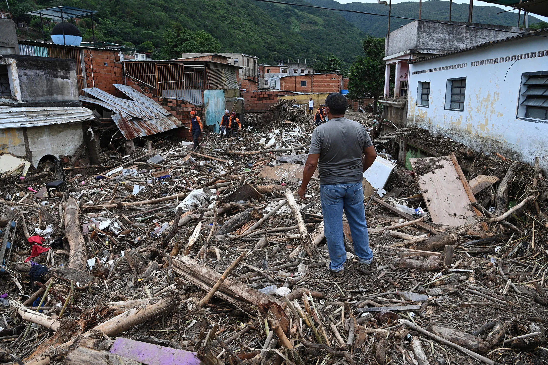 A resident&nbsp;looks at the rubble of destroyed houses washed away by a landslide during heavy rains in Las Tejerias, Aragua state, Venezuela, on Oct.&nbsp;9.