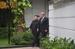 US President Donald Trump (R) walks with North Korea's leader Kim Jong Un (L) during a break in talks at the second US-North Korea summit.
