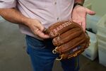 Rob Storey holds a glove made for the Texas Rangers at the Nokona manufacturing facility in Nocona, Texas.