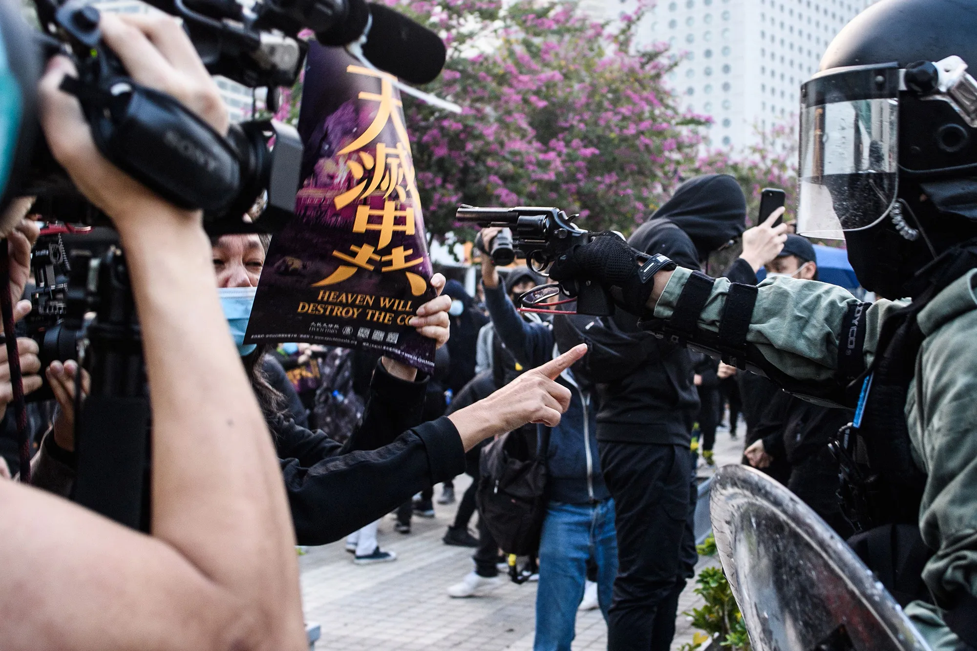 A police officer points a pistol during a rally in Hong Kong on Dec.&nbsp;22.