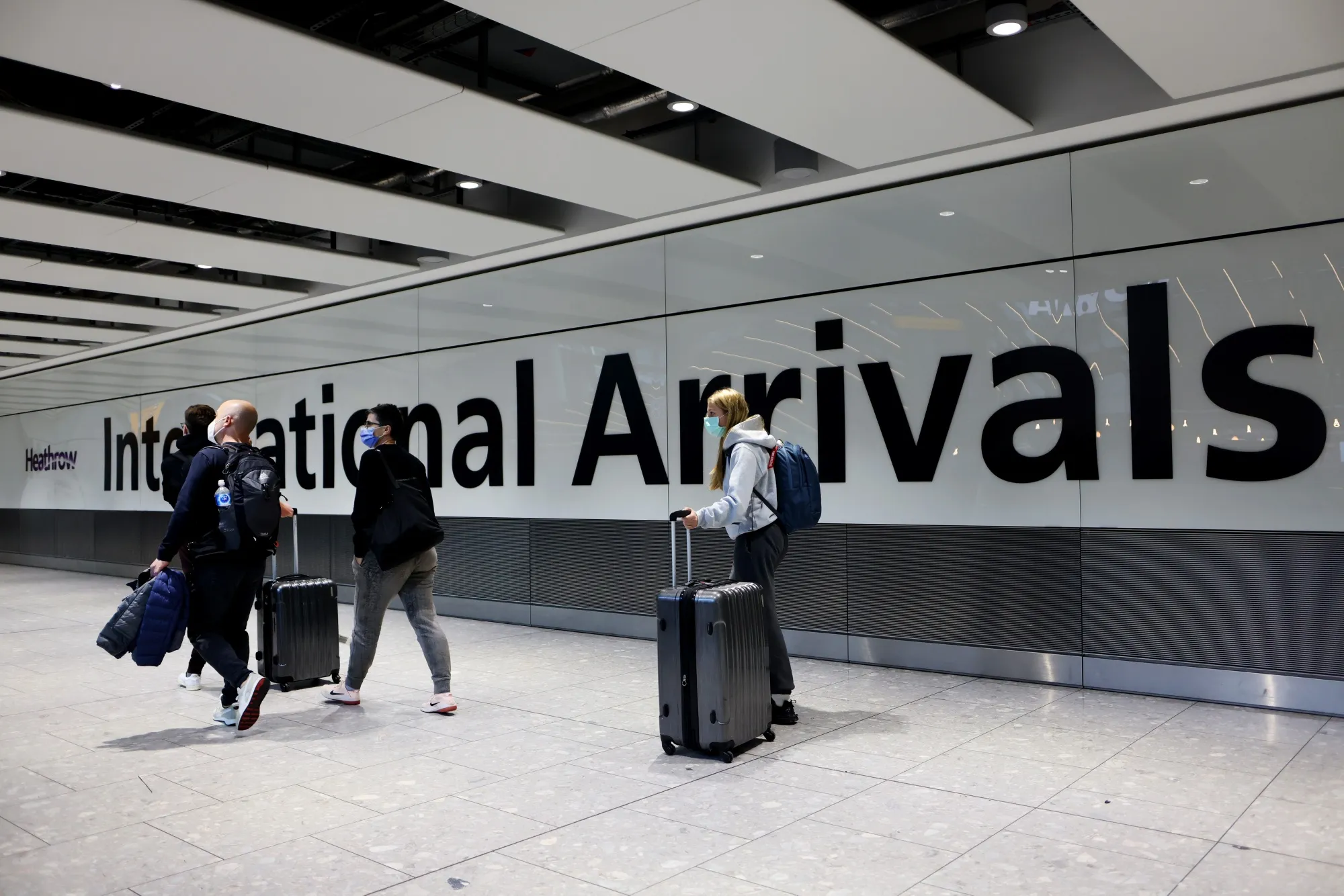 Airline passengers in the arrivals hall at Heathrow Airport in London, UK.