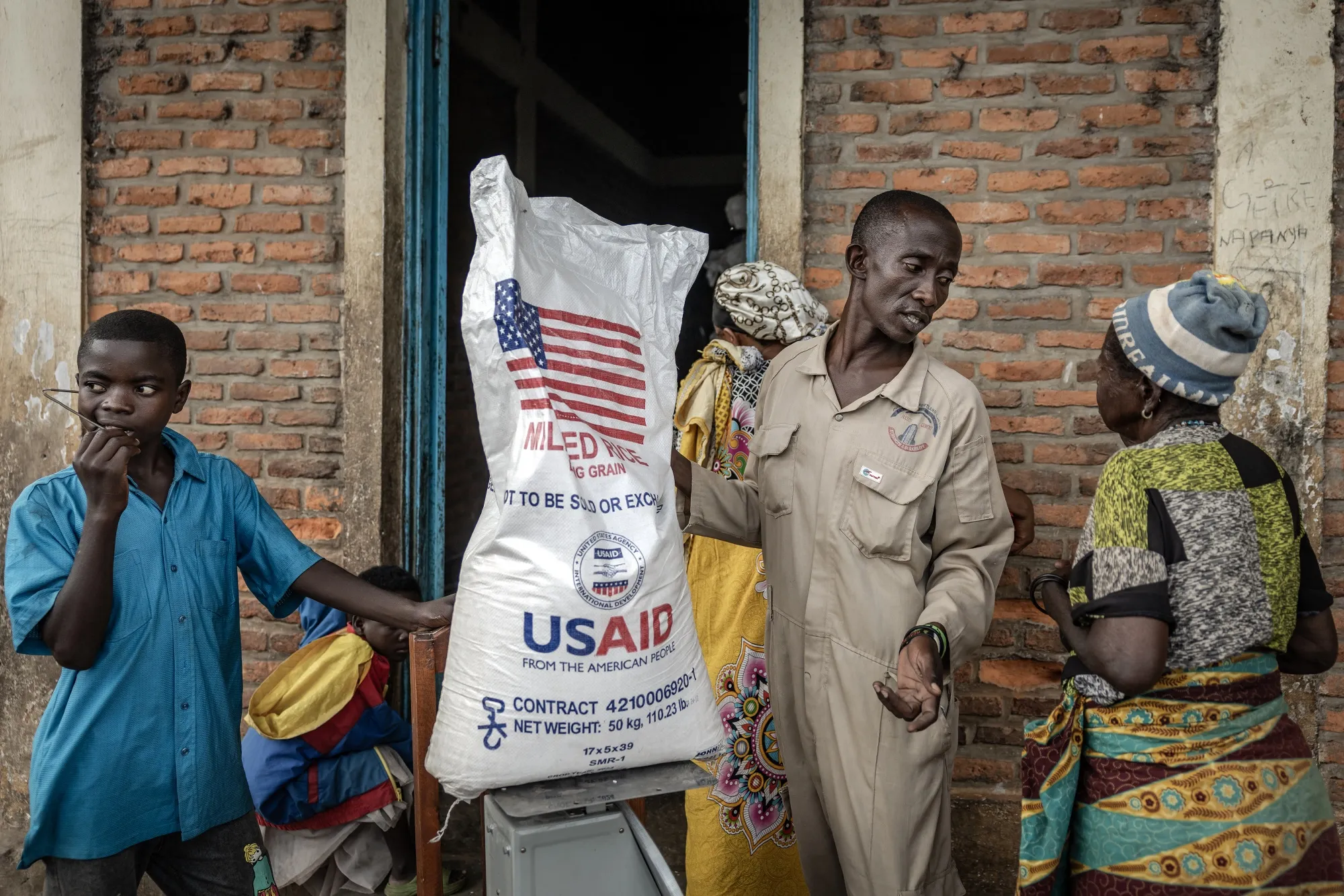 A&nbsp;government official in Burundi distributes US-provided rice in May.
