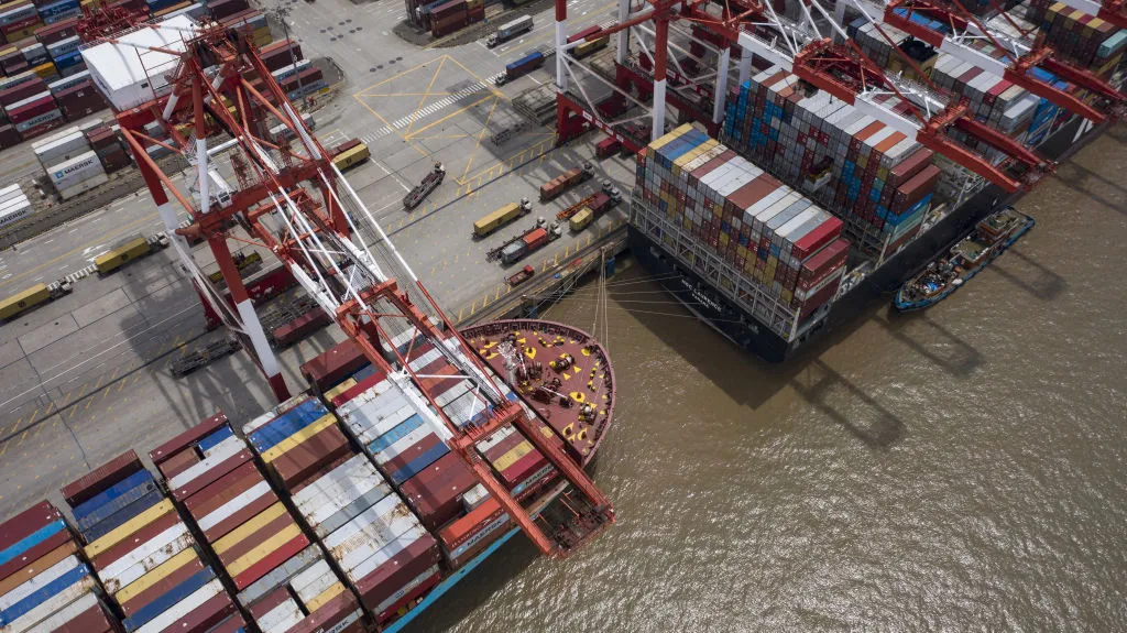 Vessels loaded with shipping containers are docked at the Yangshan Deepwater Port in this aerial photograph taken in Shanghai, China, on Sunday, July 12, 2020. U.S. President Donald Trump said Friday a phase two trade deal with China isn't under consideration, saying the relationship between Washington and Beijing has deteriorated too much.