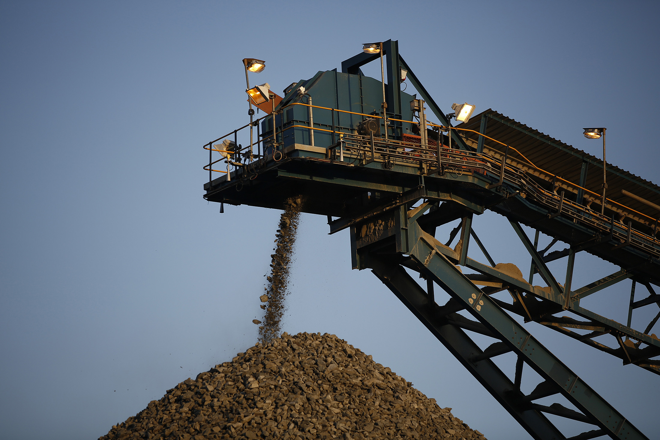 A conveyor belt deposits processed rock ore onto a dump at the Kibali gold mine in the Democratic Republic of Congo.
