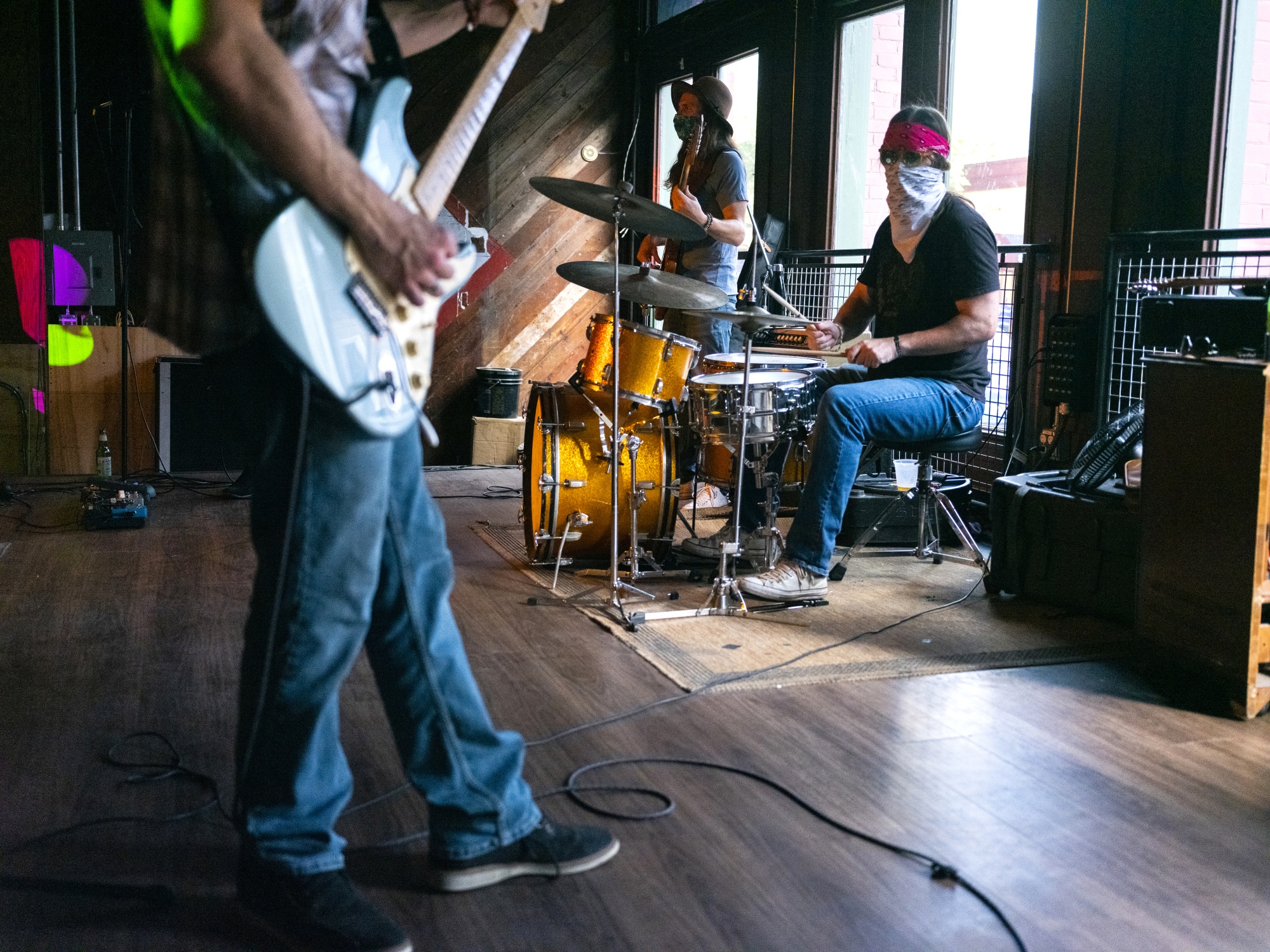 A band wearing protective face coverings plays at a bar on Sixth Street in downtown Austin on Saturday, May 23.