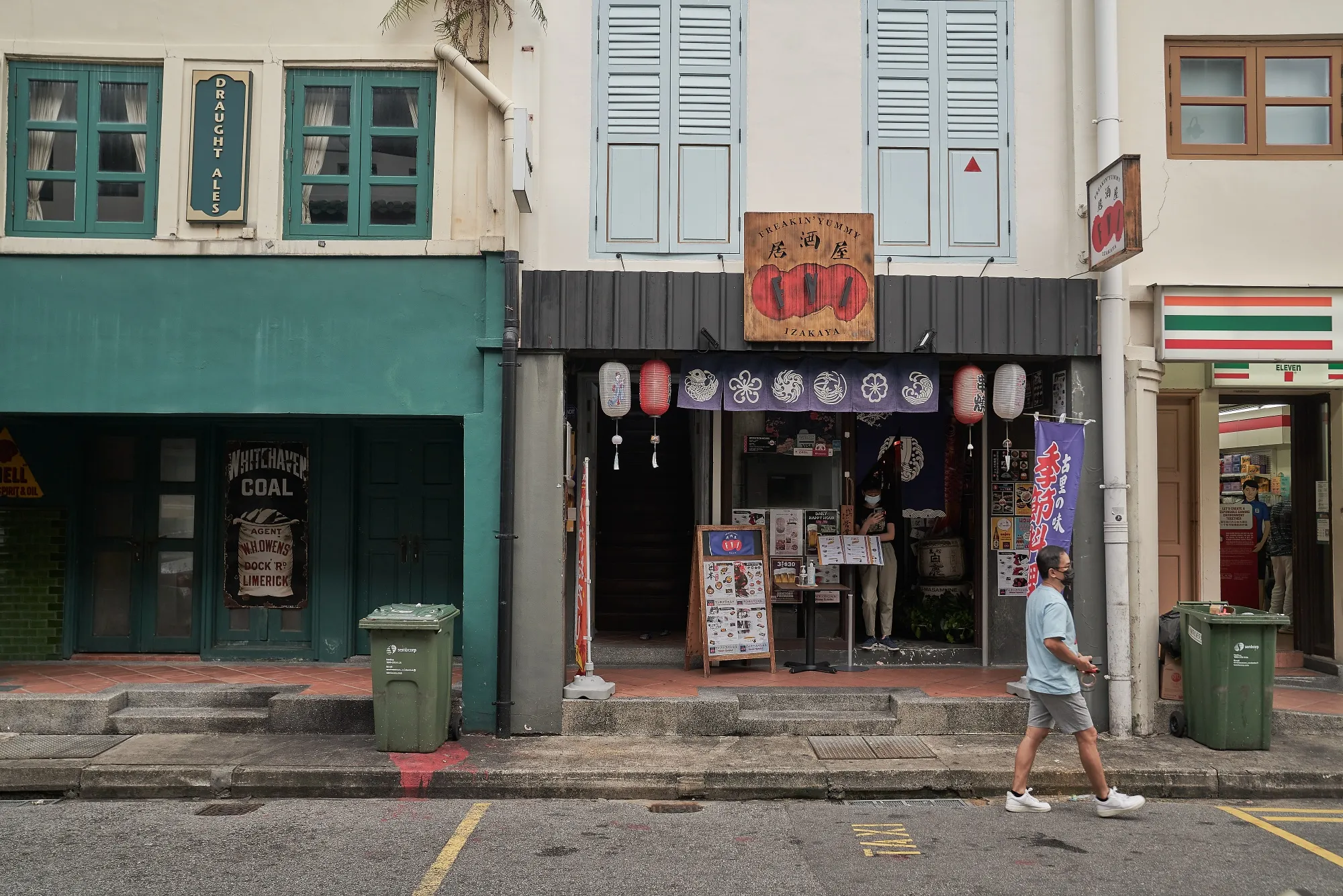 A pedestrian walks past a closed bar and restaurant open for takeaway in the central business district of Singapore on May 19.