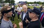 Representative Dan Donovan, center, listens to participants as he attends a property tax protest rally in the Staten Island borough of New York, Saturday, June 23, 2018.