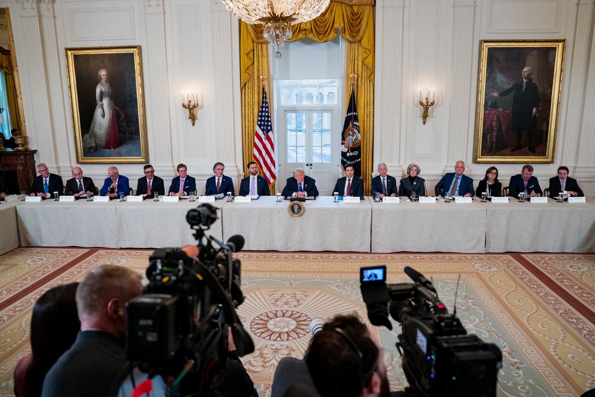 Trump, center, speaks during a meeting with oil executives in the East Room of the White House in Washington on Friday.