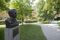 A bronze bust of Jakob Fugger, founder of the Fuggerei social housing complex, stands in a communal garden area in Augsburg, Germany.