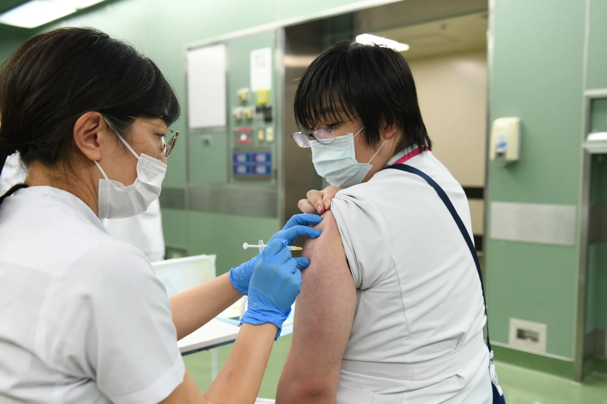 A nurse receives a booster shot of the Pfizer-BioNTech Covid-19 vaccine at Chiba University Hospital on Dec. 1.