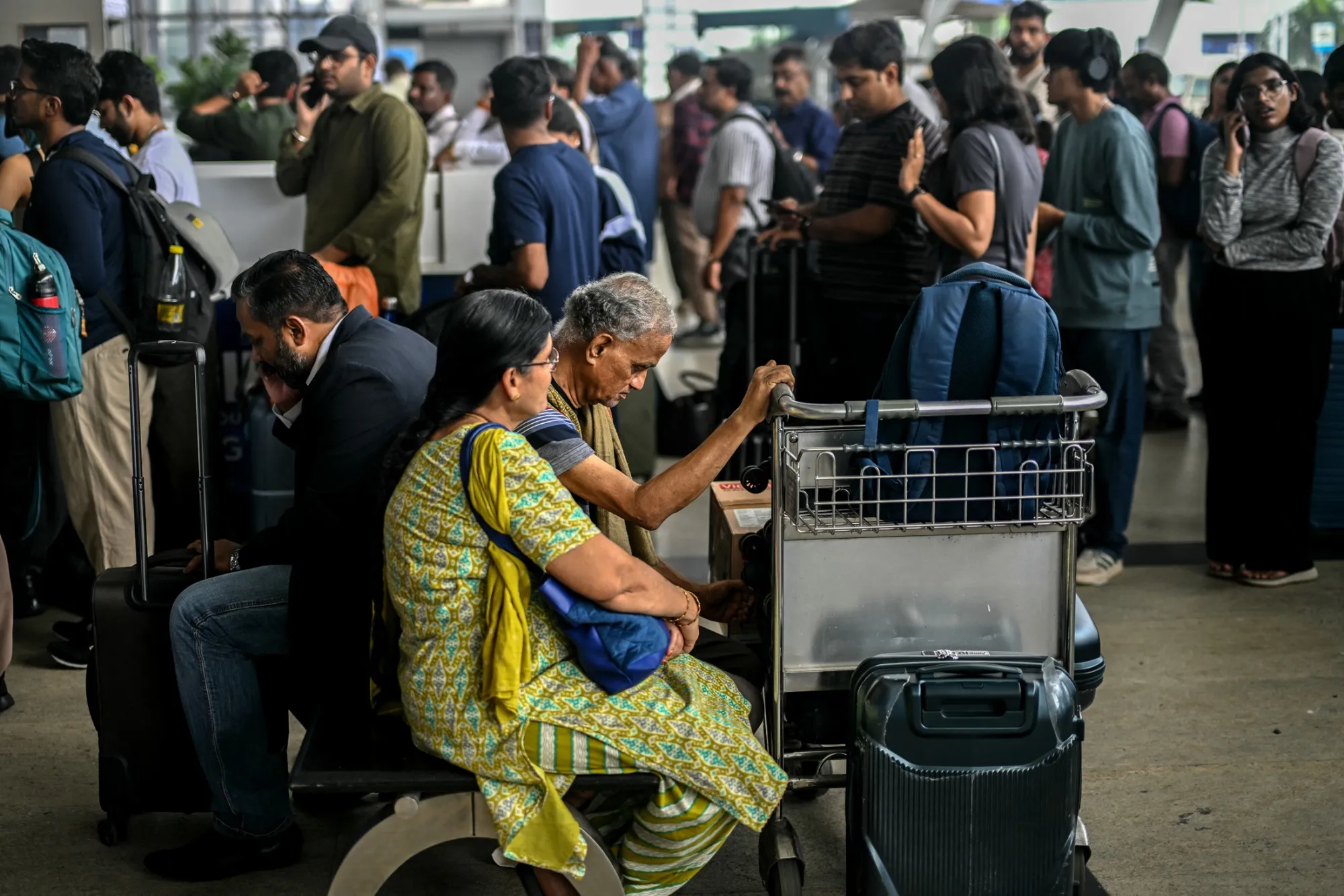 Passengers wait near an IndiGo Airlines kiosk at Chennai International Airport, on Dec. 5.