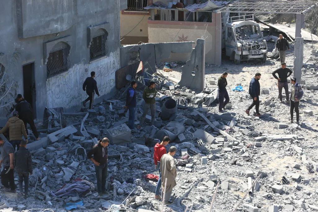 Civil defense teams and locals carry out search and rescue efforts after an Israeli attack,&nbsp;in Rafah.