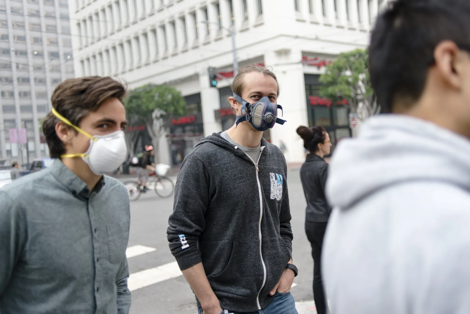 People wear masks while smoke from the Camp Fire fills the air in San Francisco, California.