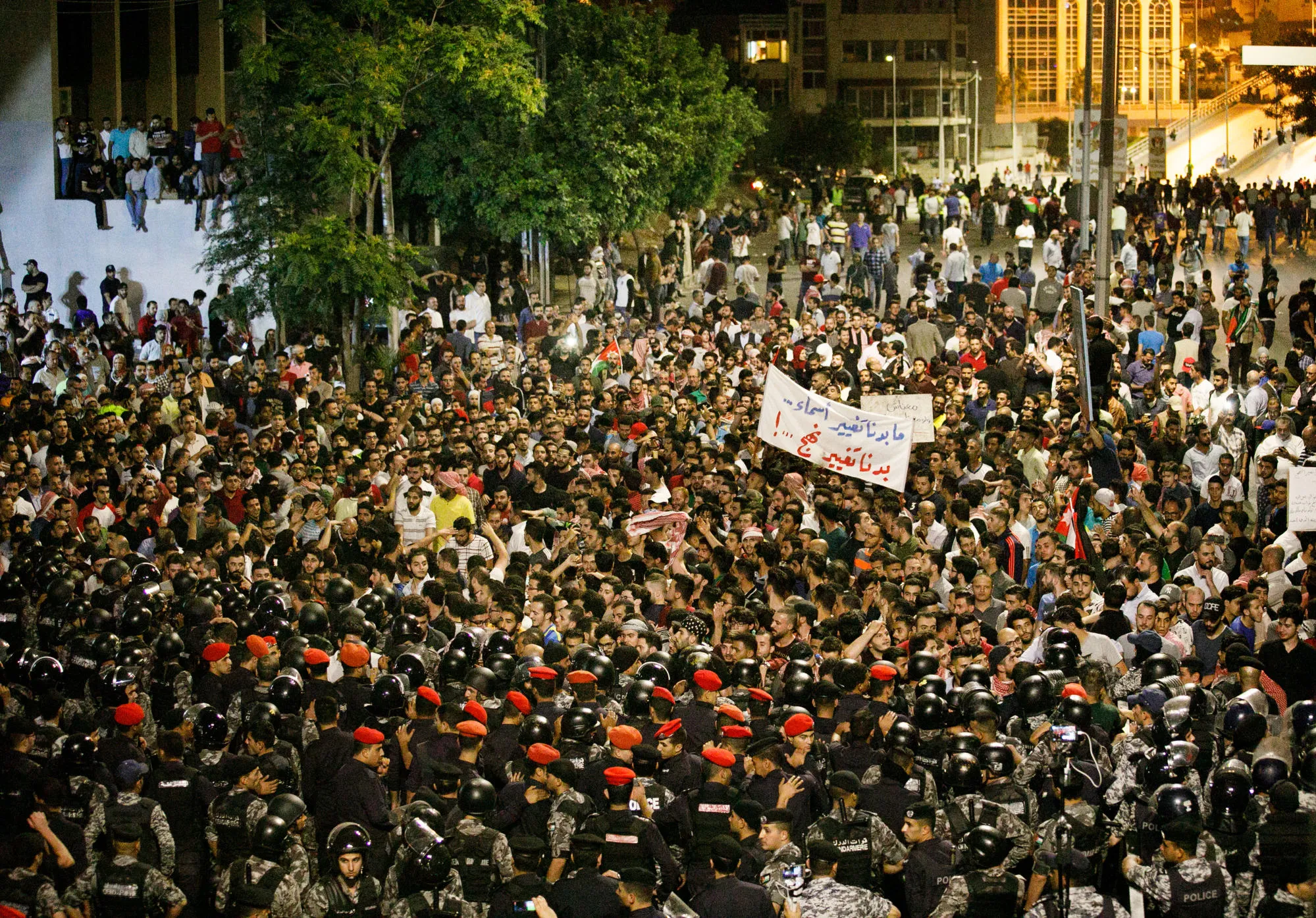 Anti riot police and security forces block the path of protesters during a demonstration against a draft income tax law near the prime minister's office in Amman, Jordan, on June 6.&nbsp;