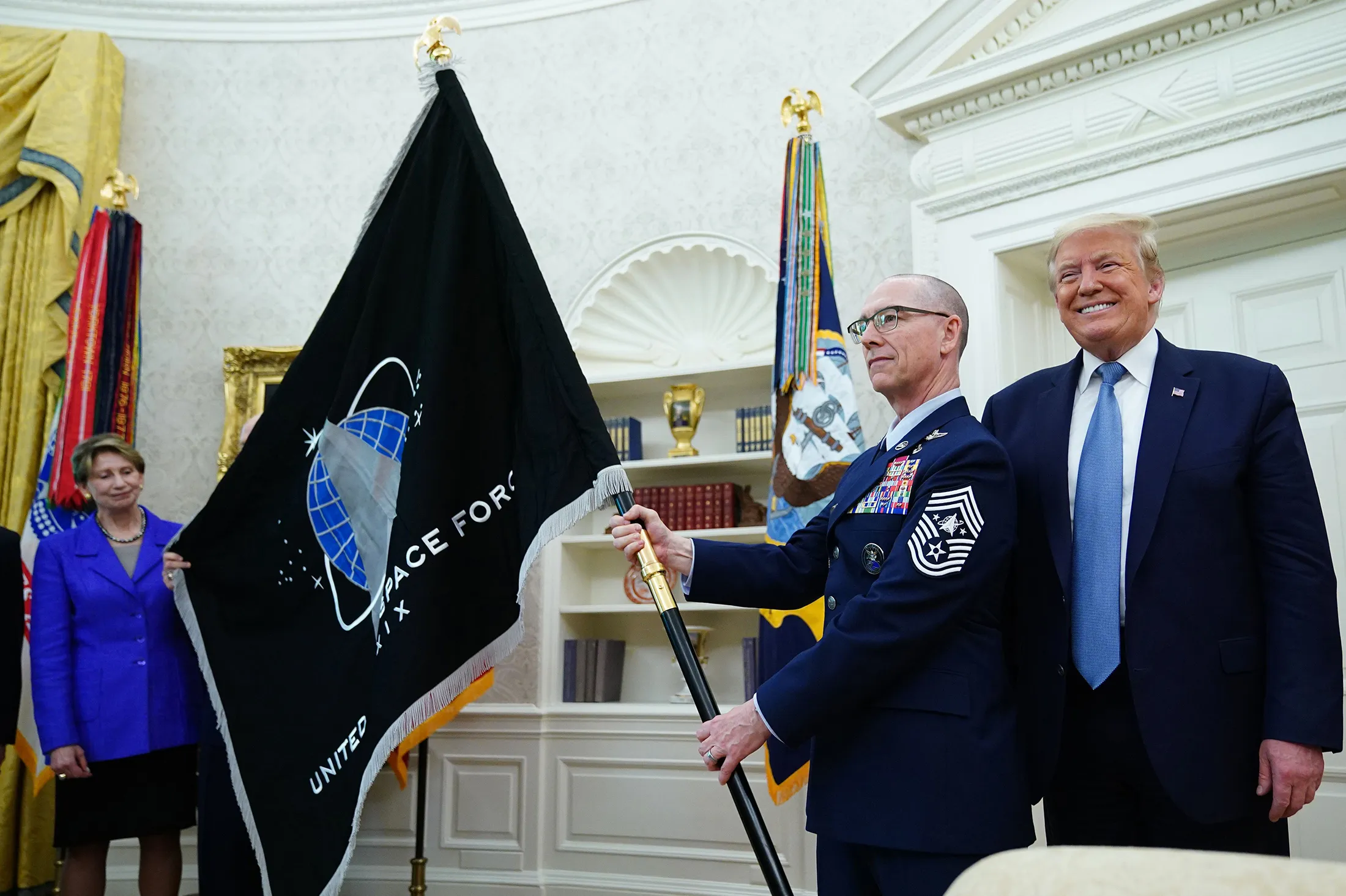 President Trump presents the U.S. Space Force flag in the Oval Officer on May 15,.