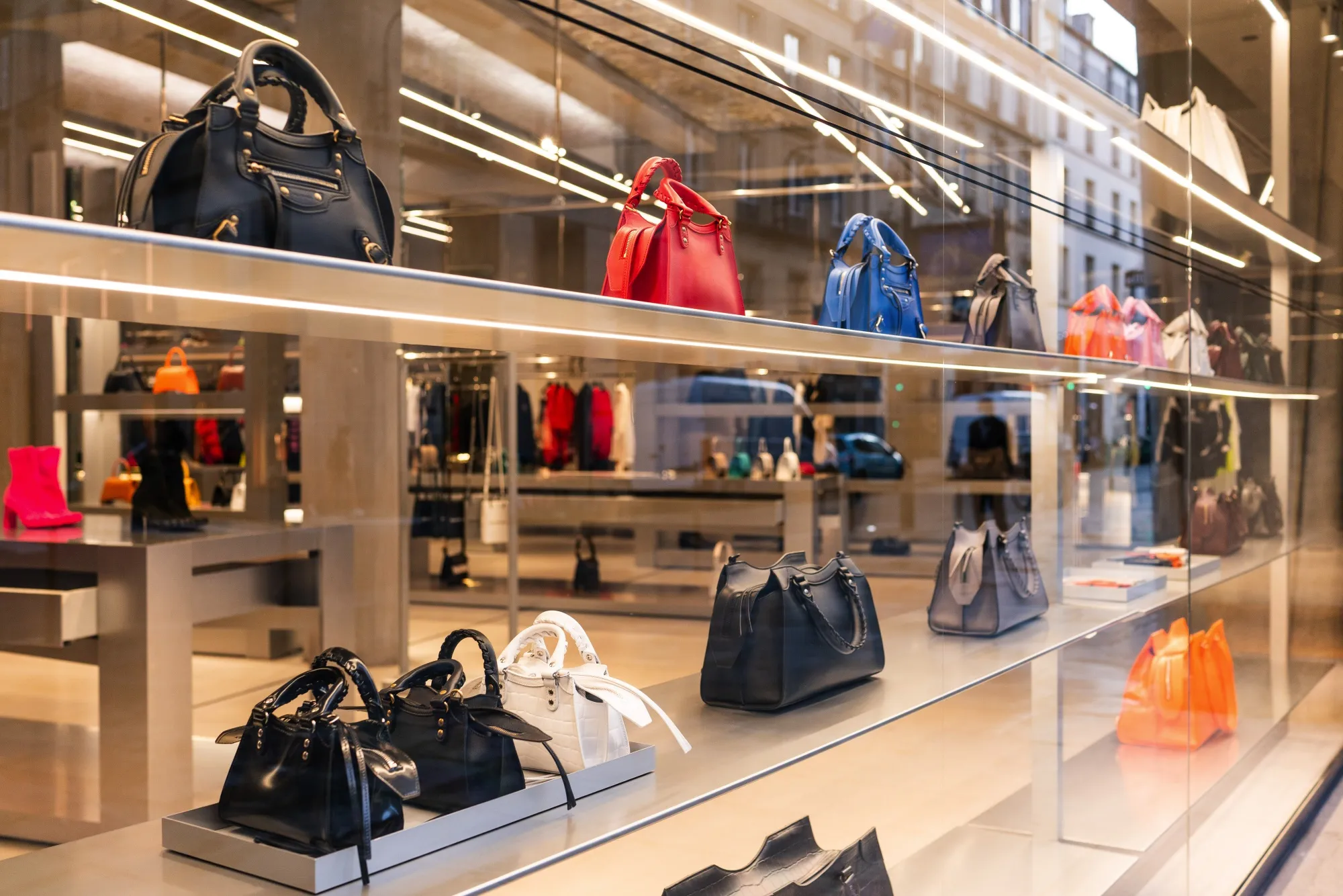 Leather handbags in the window display of a store in Paris.