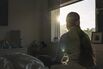 Powerful rear view shot of a teenage girl looking out of her bedroom window as the late sun streams in - negative emotion