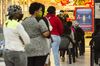Residents queue to receive their South African Social Security Agency payment in Johannesburg.