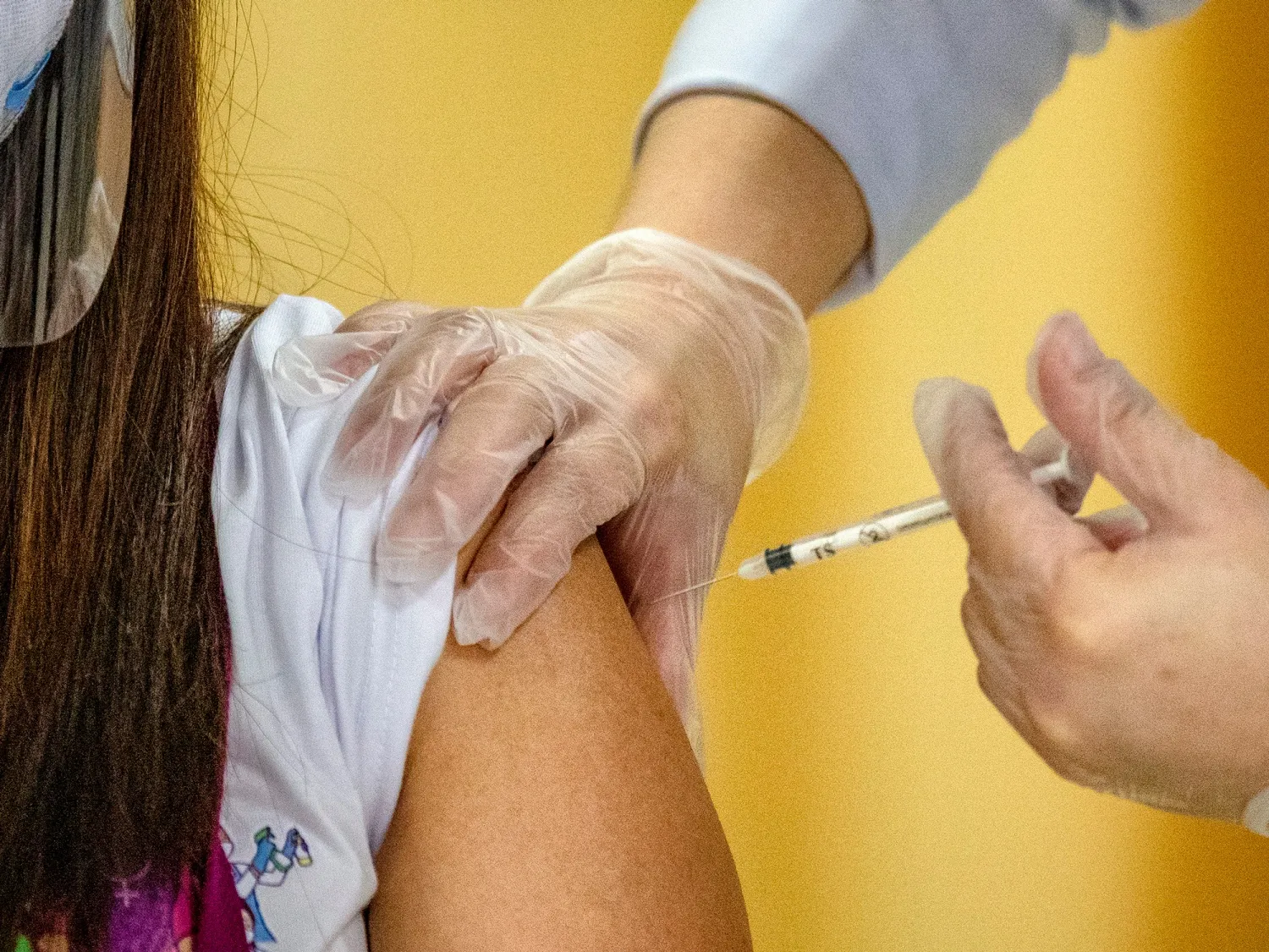 A health worker receives a shot of Sinovac Biotech's vaccine in Quezon city, Metro Manila.